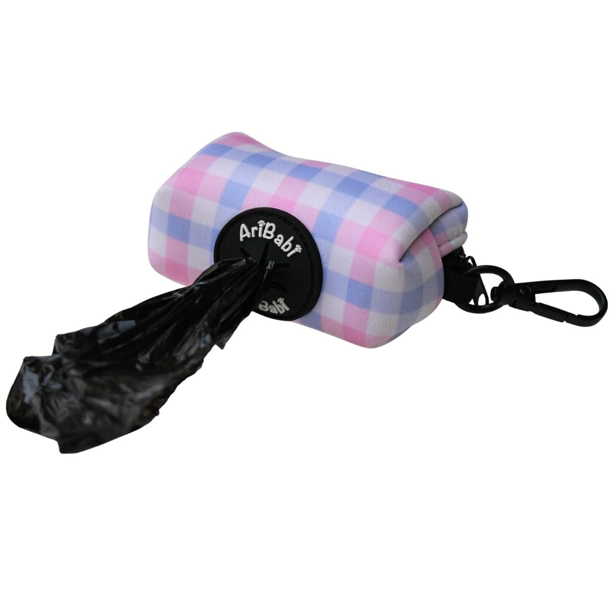 Portabolsas rosa con dibujos de cuadros de la colección Vichy dispensando una bolsa.