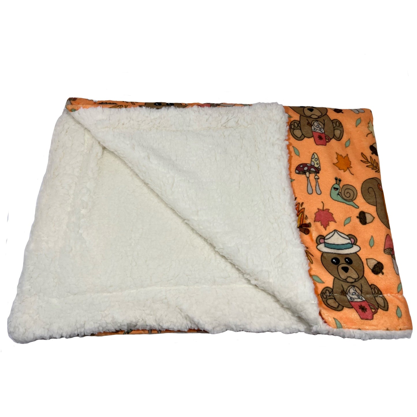 Manta suave naranja con dibujos de animales de la colección Yosemite mostrando el borreguito interno.