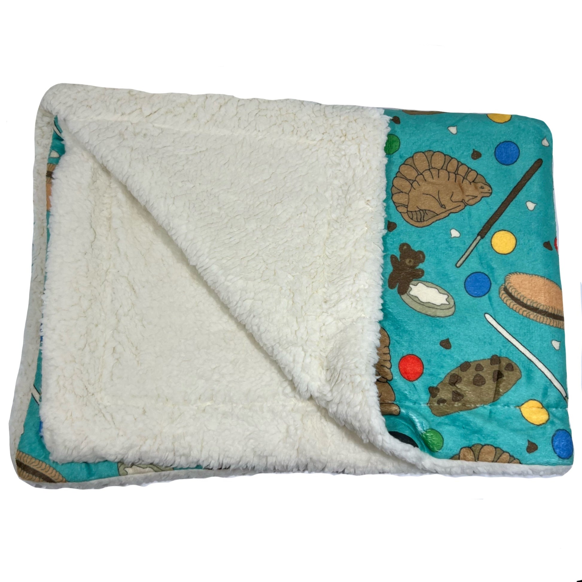 Manta suave verde con dibujos de galletas de la colección Cookies mostrando interior de borreguito.